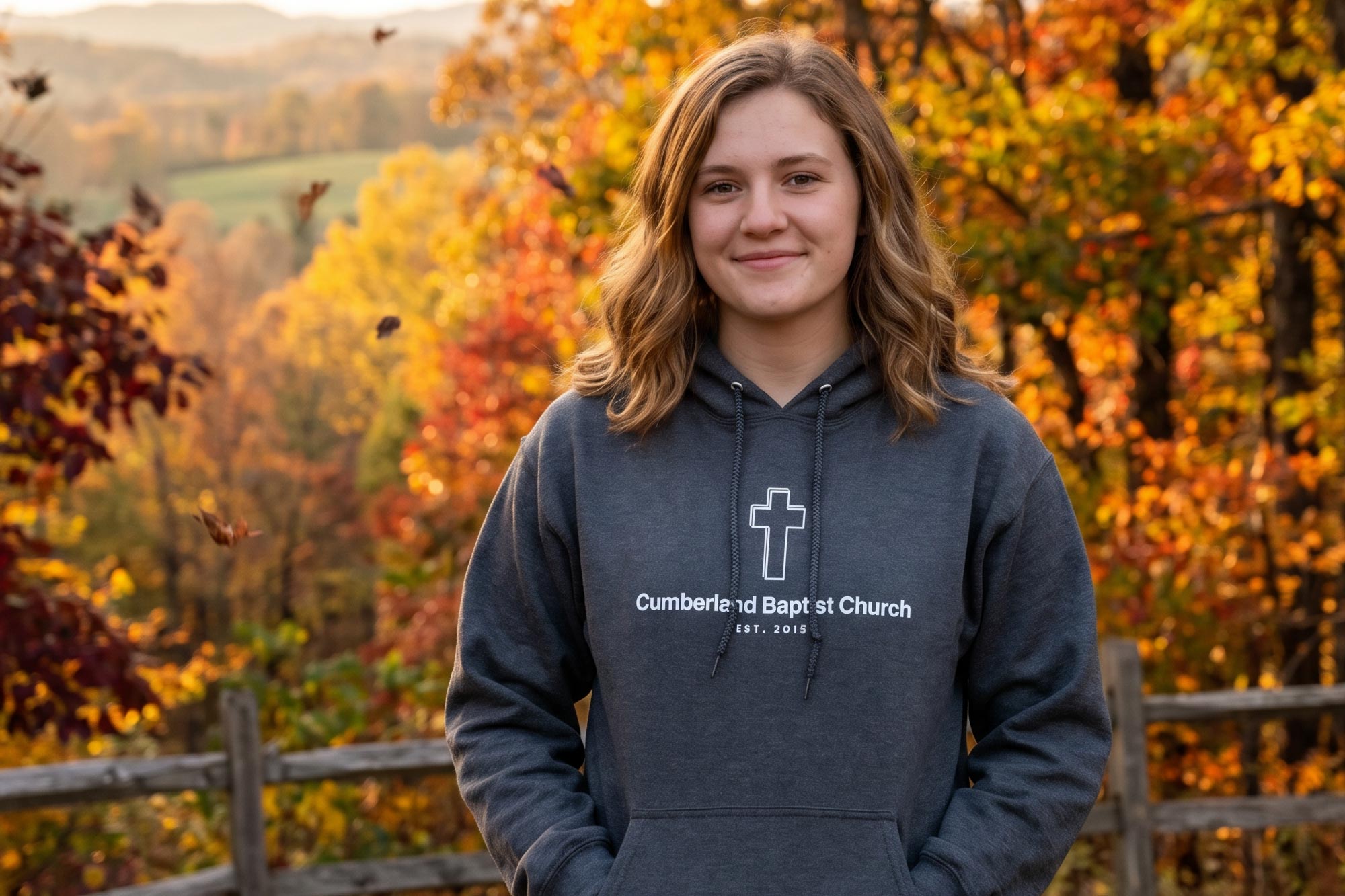 Young woman wearing a screen printed hoodie with "Cumberland Baptist Church and cross on front