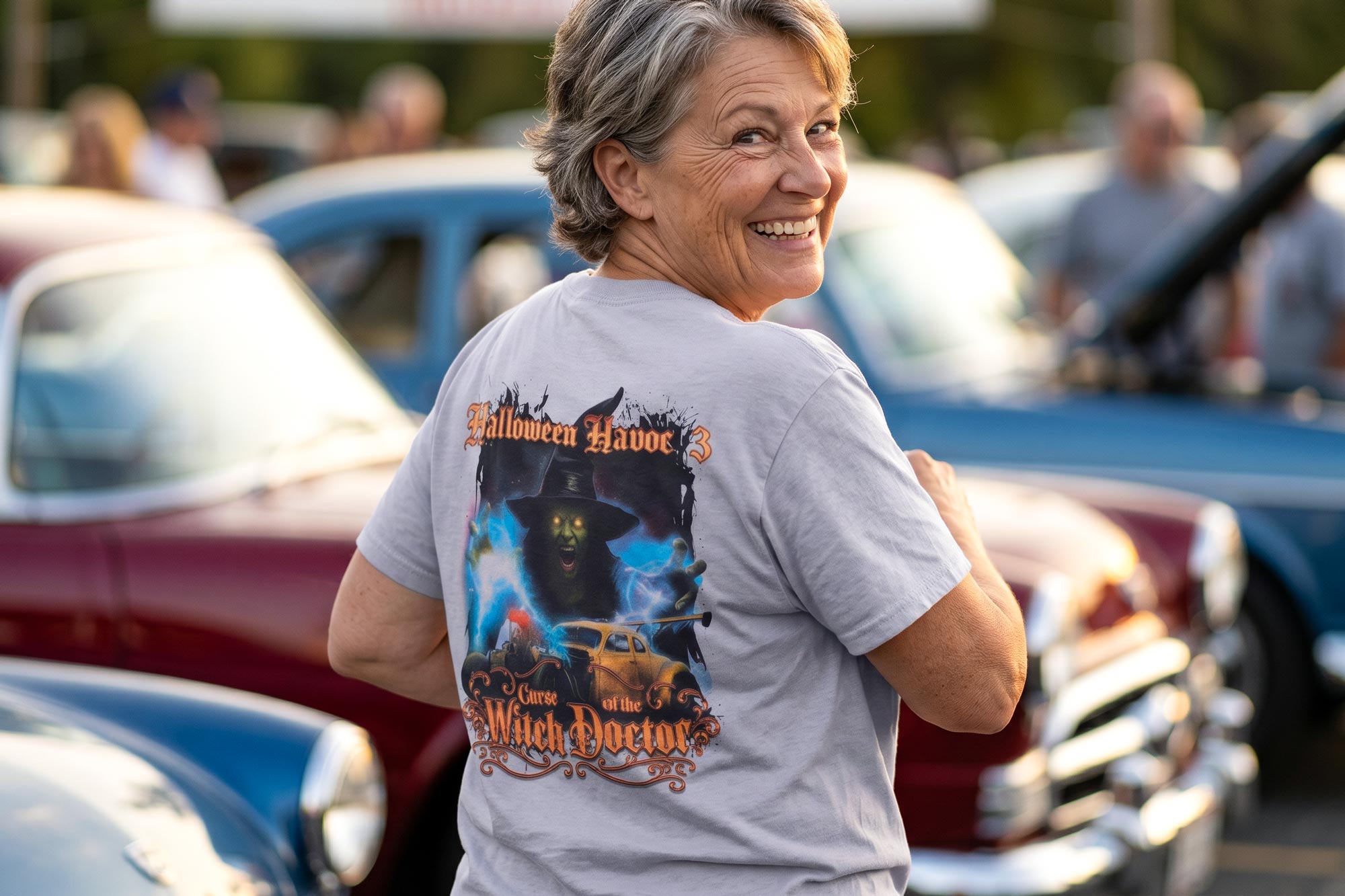 Woman wearing multi-color screen printed t-shirt at a car show