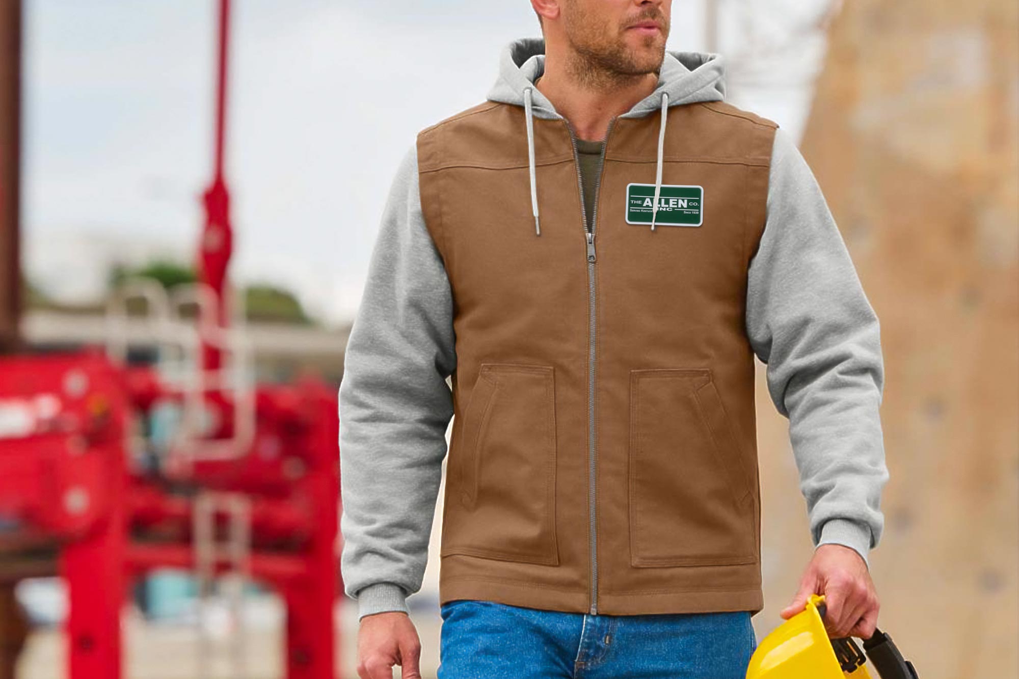 Construction worker with vest sporting a patch with "The Allen Company"